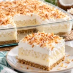 Layered coconut cream lush with graham crust and whipped topping