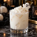 Creamy Drunk Ghost Halloween cocktail with whipped cream and marshmallow ghost garnish