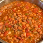 Homemade Mexican beef chili with pinto beans in a stainless steel pot